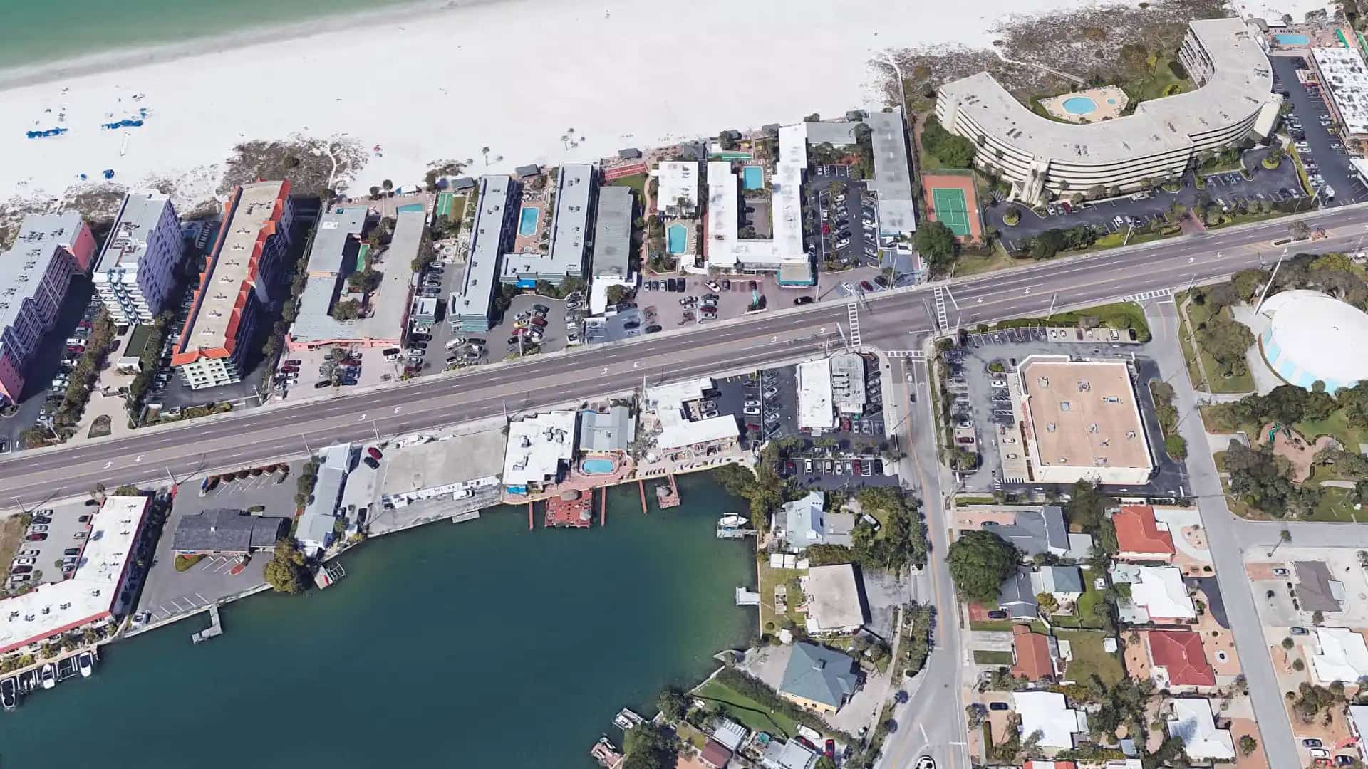 Aerial view of a waterfront resort and surrounding area
